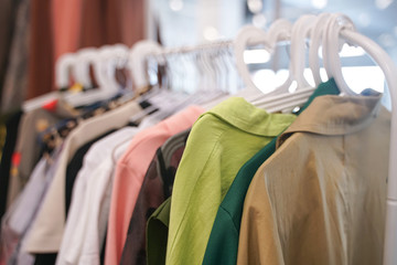 fashion stylish clothes hanging on hangers in the store. nobody.