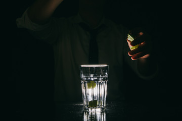 Professional bartender making Mojito cocktail