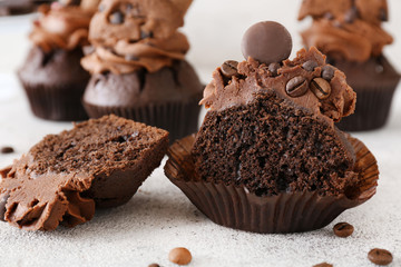 Tasty chocolate cupcake on light background