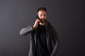 A serious young man talking on his phone