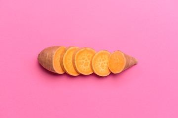 Raw cut sweet potato on color background