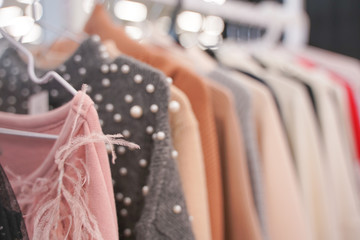 fashionable clothes hanging on hangers in the store. nobody.