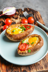Baked sweet potato with egg and tomato on plate