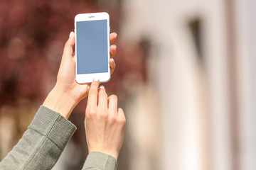 Young woman with mobile phone outdoors