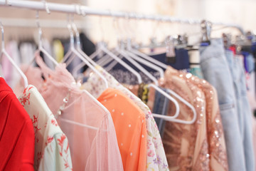 fashion stylish clothes hanging on hangers in the store. nobody.