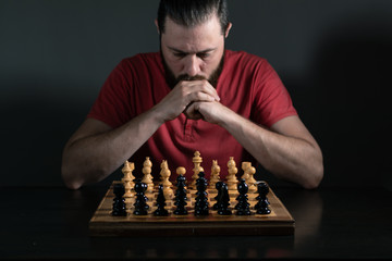 Beard man thinking of what chess move to perform. Business decision mking concept