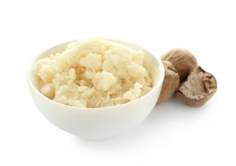Bowl with shea butter on white background