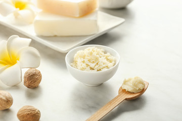 Bowl with shea butter on light table