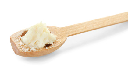 Spoon with shea butter on white background