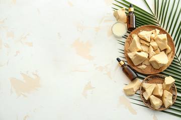 Composition with cocoa butter and cosmetics on light background