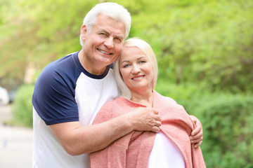 Portrait of happy mature couple in park