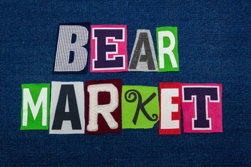 BEAR MARKET text word collage, multi colored fabric on blue denim, falling price and demand concept, horizontal aspect