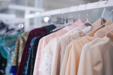 Obraz premium fashionable clothes hanging on hangers in the store. nobody.