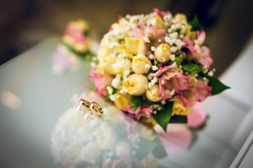 wedding bouquet and wedding rings. the attributes of the groom. newly married couple. the preparations of the groom
