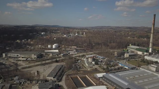 Gorlice, Poland - 3 9 2019: Industrial region of the Carpathian city. Top view of the refinery and auxiliary buildings. Video shot by drone or quadrocopter. Vanity of the day at the factory. Planning 