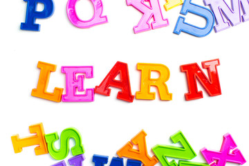 Heap of plastic colored alphabet letters close up. Learn