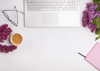 Modern feminine workplace with coffee and flowers