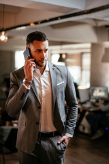 Portrait of attractive businessman in gray suit