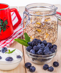  Jogurt z jagodami. Czarne jagody w misce podane na sniadanie. Musli z owocami, swieze owoce.  Zdrowe i pozywne sniadanie. © ff25