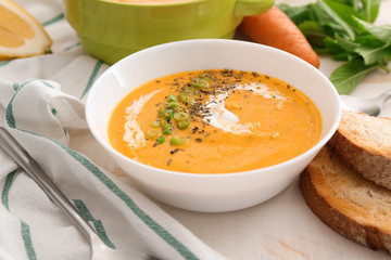 Bowl of tasty cream soup on table