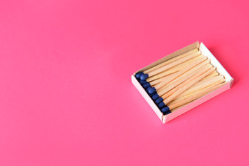 Box with matches on color background