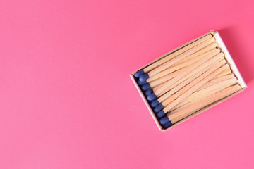 Box with matches on color background
