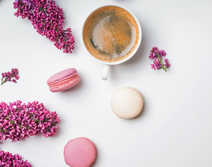 Fototapeta na wymiar Creative spring composition with coffee, macarons and lilac flowers