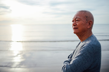 Fototapeta na wymiar Portrait of Senior old man relax on the beach smile and happy face
