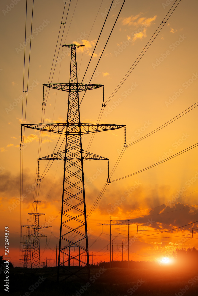 Wall mural silhouette high voltage electric towers at sunset time. high-voltage power lines. electricity distri