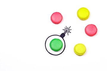 Sweet bomb. Different color macaroons and hand drawn bomb on white background. Explosion creative concept.