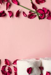Towels, potpourri and scented sticks on pink background with copy space for your text; wellness or spa background