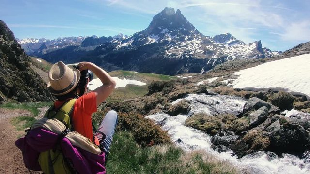 woman hiker take a photo the mountain, Pic du Midi d Ossau in the french Pyrenees