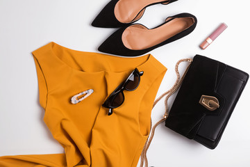 Beautiful mustard color dress, suede shoese and other feminine accessories.