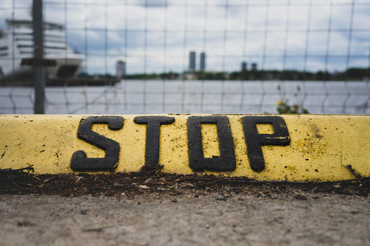 The Inscription Stop On The Parking Curb