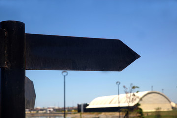 Black signboard showing the way