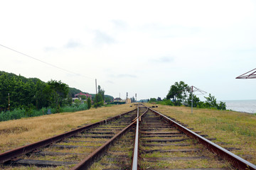 Fototapeta na wymiar Two railway tracks merge together. Line of railway crossing. Detail of a railway tracks 