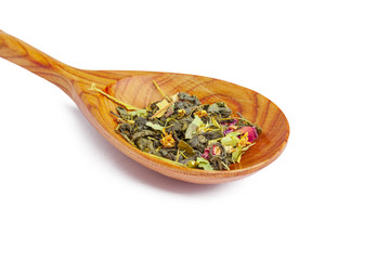 Dried tea on a wooden spoon, isolated on white