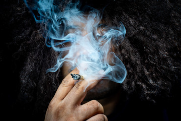 Marijuana joint in the hand, Concepts of medical marijuana use and legalization of the cannabis.
