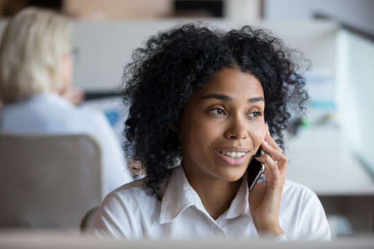 African American businesswoman talking on phone at workplace