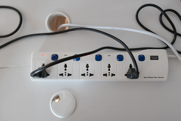 Top view of power strip in office workplace table.