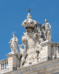 statue on the royal palace of madrid spain