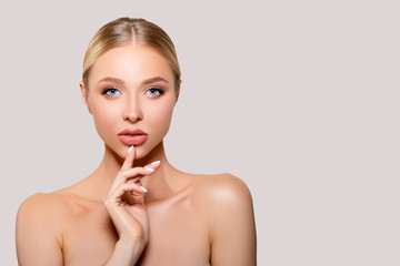 Beautiful young Woman touches her face with her hand, perfect clean smooth well-groomed Skin....