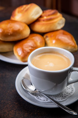 Coffee white cup, croissants on dark retro background, selective focus. Breakfast concept