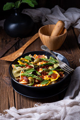 Pasta salad with green asparagus, olives and parma ham