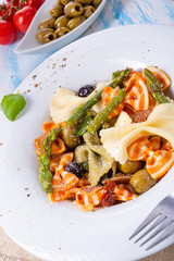 colorful farfalle with green asparagus olives and parma ham