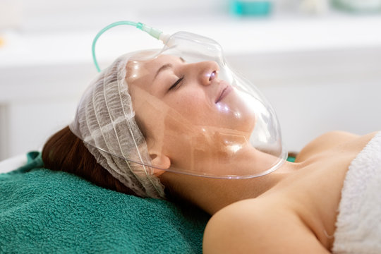 Young Woman Receiving Cosmetic  Treatment With Oxygen Mask