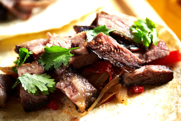 Beef steak with coriander on tortilla
