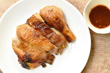 grilled chicken cutting on plate dipping with spicy sauce