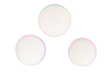 Three colorful soap bubbles flying on white background