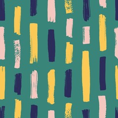 Creative seamless pattern with vivid paint traces or smudges on green background. Artistic backdrop with vertical brushstrokes. Modern vector illustration in grunge style for textile print, wallpaper.
